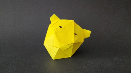 a 3d tiger head in origami, folded with yellow paper