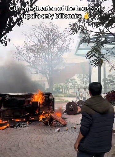 Photo of a burning car outside a palatial home with the caption “Current situation of the house of Nepal's only billionaire”