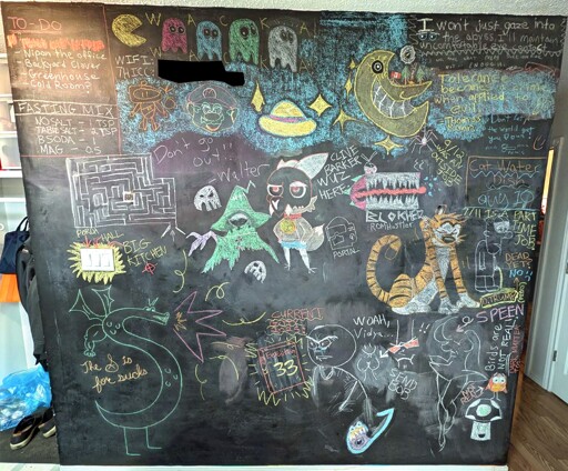 Back hallway wall was painted with Rustoleum Chalk Board paint, covered in various doodles.