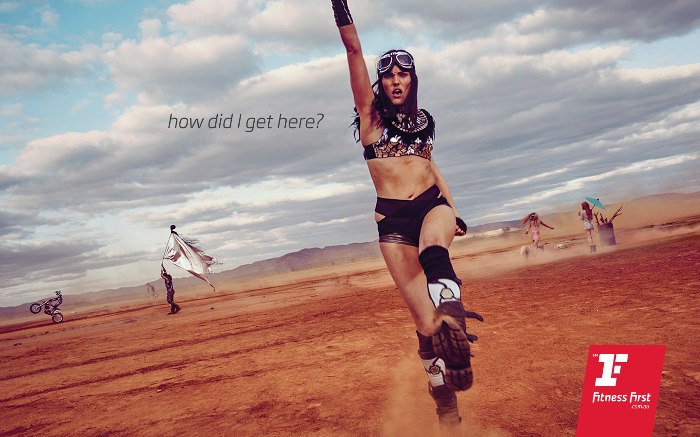 gym billboard photo of girl at burning man with tagline “how did I get here?”